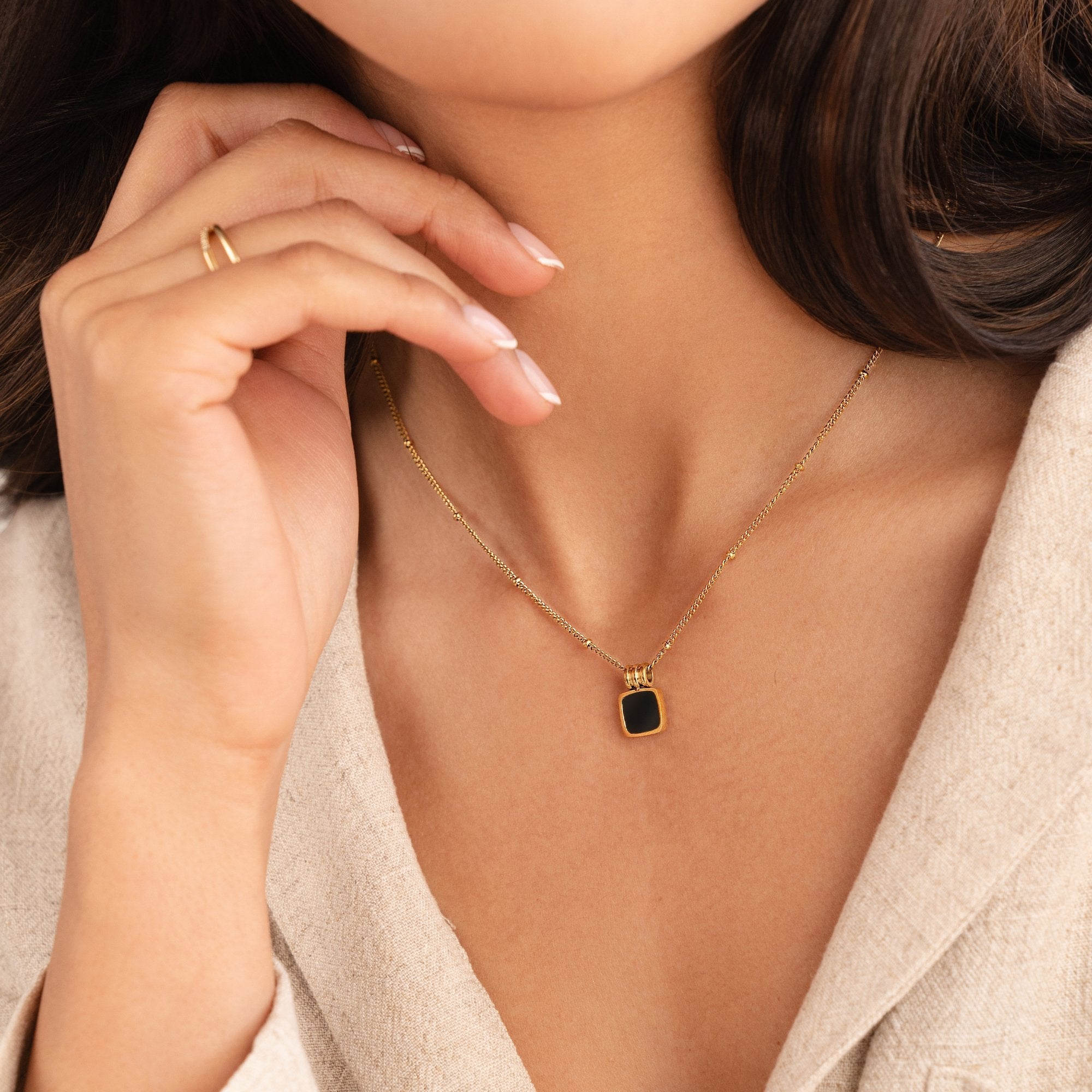 Selina – Gold Necklace with Dark Stone.