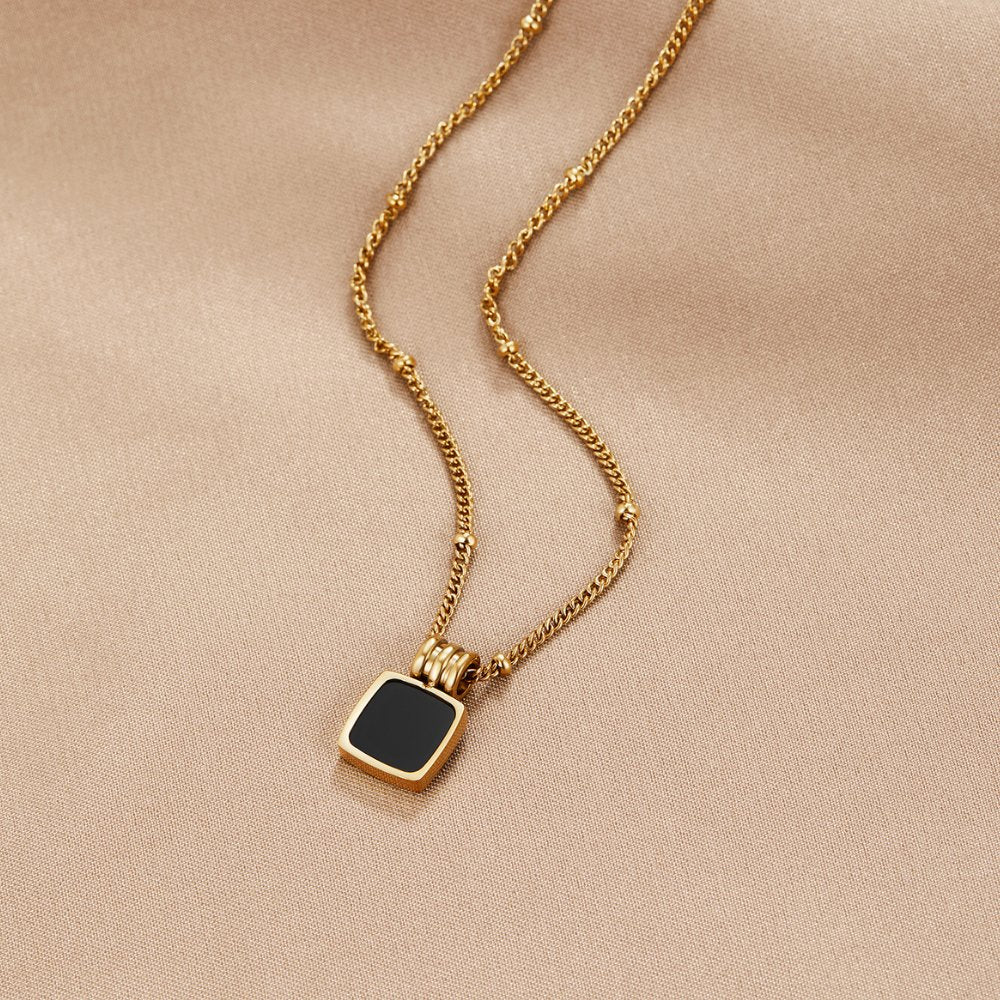 Selina – Gold Necklace with Dark Stone.